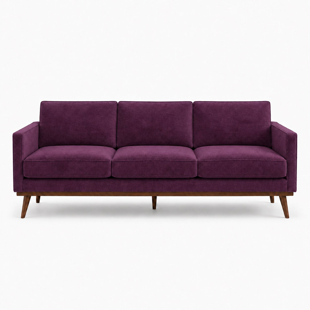 Gian Fabric in color Plum made on a sofa is a Solid Shiny Velvet Fabric that is good for Drapery & Curtain Fabric and Upholstery Fabric