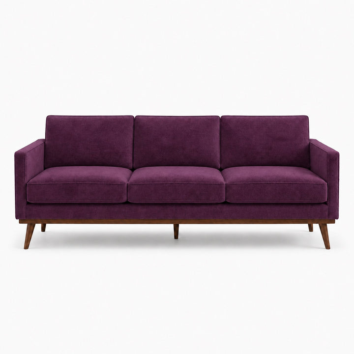 Gian Fabric in color Plum made on a sofa is a Solid Shiny Velvet Fabric that is good for Drapery & Curtain Fabric and Upholstery Fabric