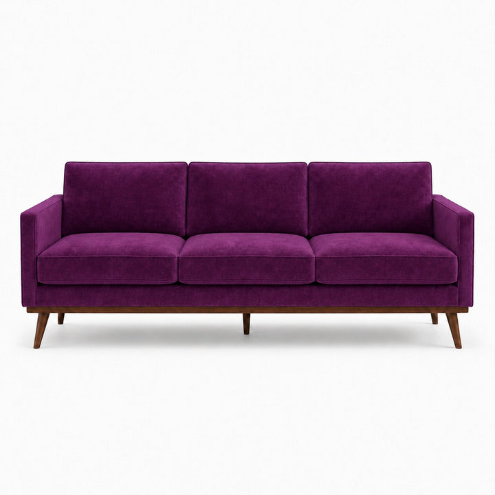 Gian Fabric in color Aubergine made on a sofa is a Solid Shiny Velvet Fabric that is good for Drapery & Curtain Fabric and Upholstery Fabric