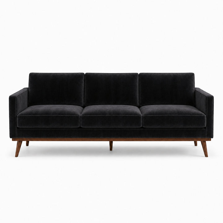 Gian Fabric in color Black made on a sofa is a Solid Shiny Velvet Fabric that is good for Drapery & Curtain Fabric and Upholstery Fabric