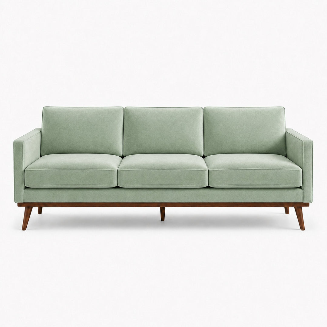 Gian Fabric in color Teal made on a sofa is a Solid Shiny Velvet Fabric that is good for Drapery & Curtain Fabric and Upholstery Fabric